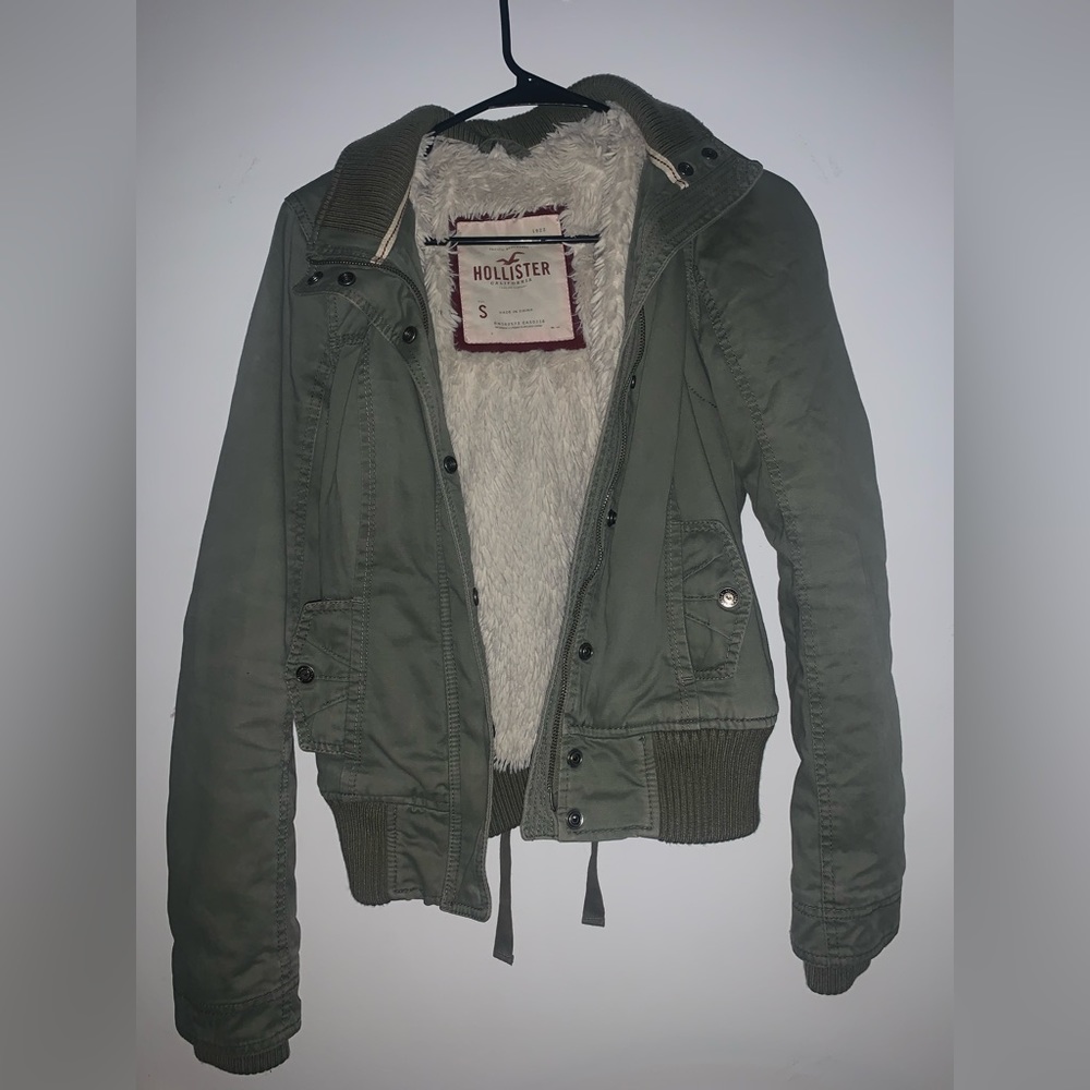 a very thick navy green coat lined with fur